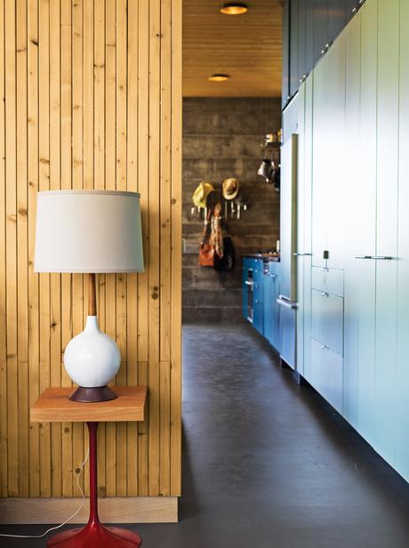 Modern kitchen hallway with wood-paneled wall 