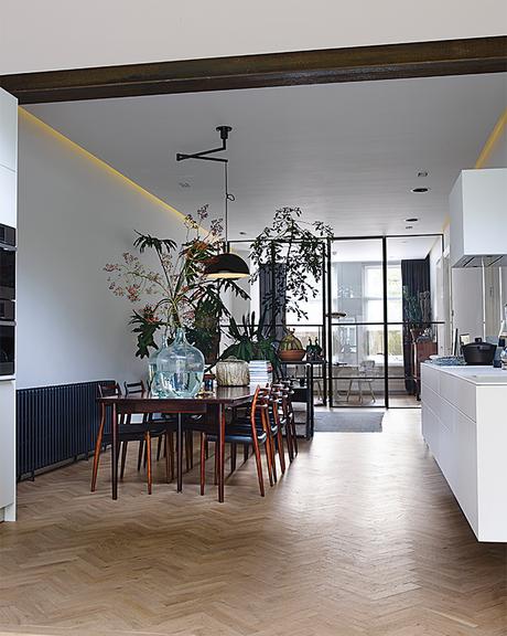 Amsterdam loft with open dining room and succulents between spaces