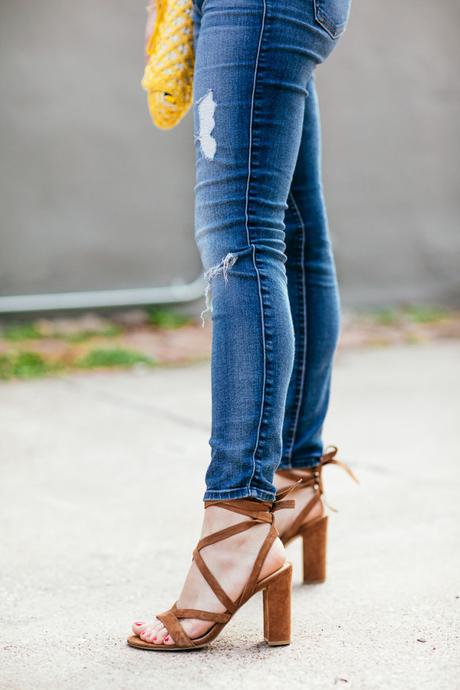 Amy Havins wears ripped 7 for all mankind jeans and a white blouse paired with ivanka trump shoes.