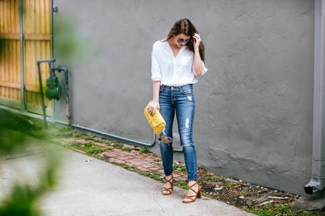 Amy Havins wears ripped 7 for all mankind jeans and a white blouse paired with ivanka trump shoes.