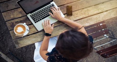 Woman working on her laptop at cafe