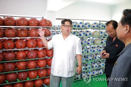 Kim Jong Un discusses products of the Pyongyang Sports Apparatus Factory (Photo: KCNA-Yonhap).