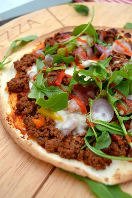 tortillas used as pizza bases topped with spicy beef, veg and cheeses