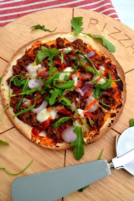tortillas used as pizza bases topped with spicy beef, veg and cheeses