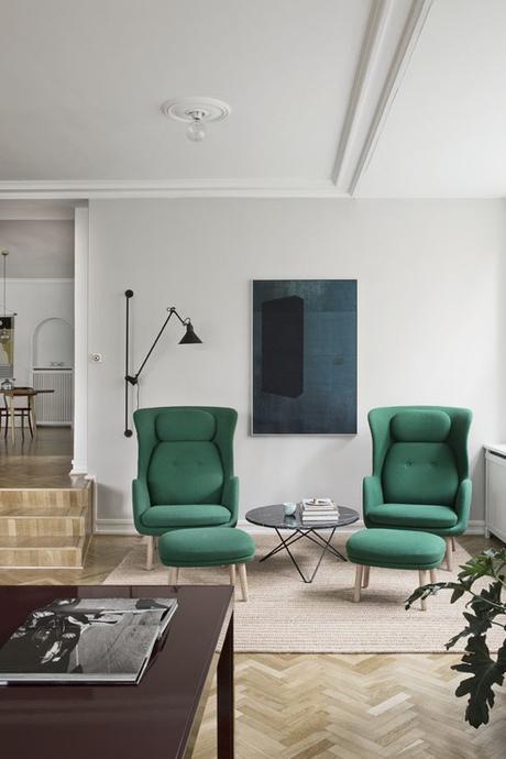 Modern Green Chairs In Sunken Living Room With Herringbone Floors 