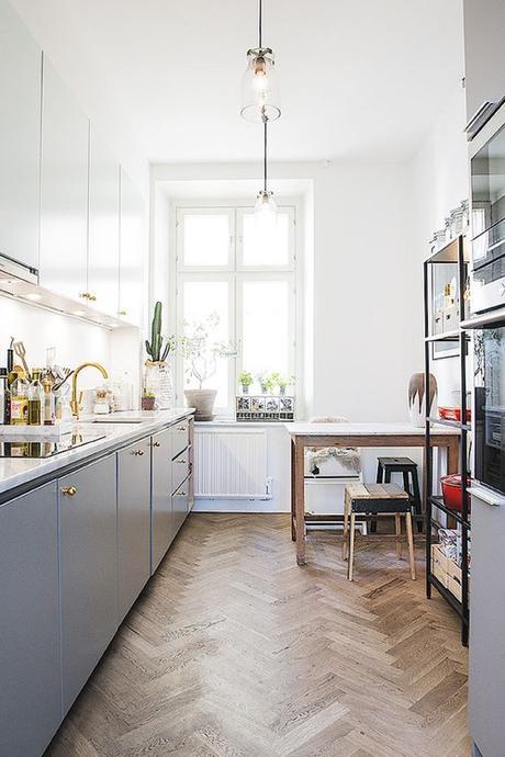 Kitchen In Stockholm Apartment With Grey Cabinets & Brass Faucet