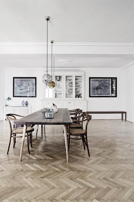 Neutral Modern Dining Room With Herringbone Wood Flooring nd Gallery Wall