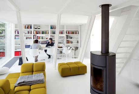 Modern living room with free Tufty-Time sofa by Patricia Urquiola, a Soft Grid blanket by Established & Sons, and a wood-burning stove by Stuv.