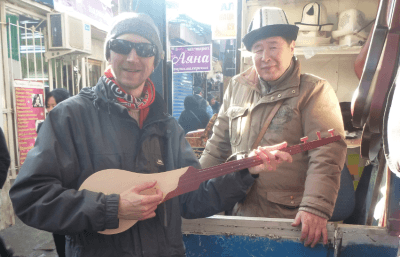 Backpacking in Kyrgyzstan: My Top 20 Sights in Bishkek Playing Kyrgyz komuz instrument in Bishkek