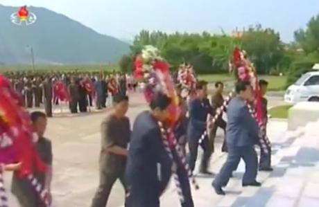 Floral wreaths are delivered to the foot of a Kim Hyong Jik statue in Chunggang County, Chagang Province on June 5, 2016 (Photo: Korean Central TV).