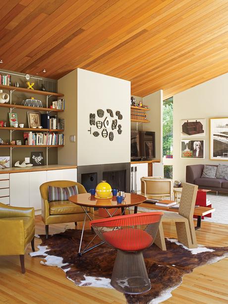 Modern living room with redwood ceiling and chairs by Knoll and Vitra