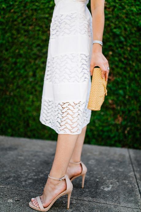 Dallas blogger, Amy Havins, wears a white shoshanna midi dress.