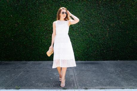 Dallas blogger, Amy Havins, wears a white shoshanna midi dress.