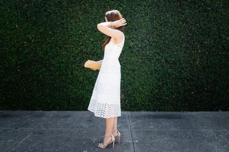 Dallas blogger, Amy Havins, wears a white shoshanna midi dress.