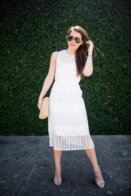 Dallas blogger, Amy Havins, wears a white shoshanna midi dress.