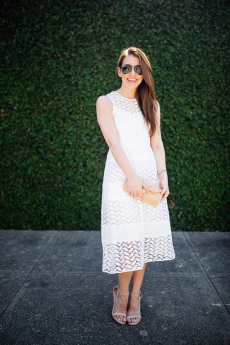 Dallas blogger, Amy Havins, wears a white shoshanna midi dress.