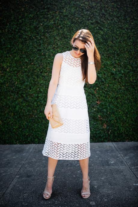 Dallas blogger, Amy Havins, wears a white shoshanna midi dress.