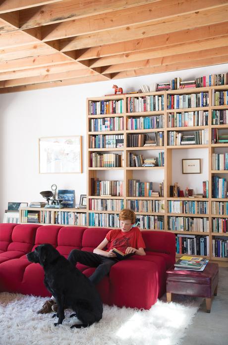 Family room with red B&B Italia sofa and furry white rug