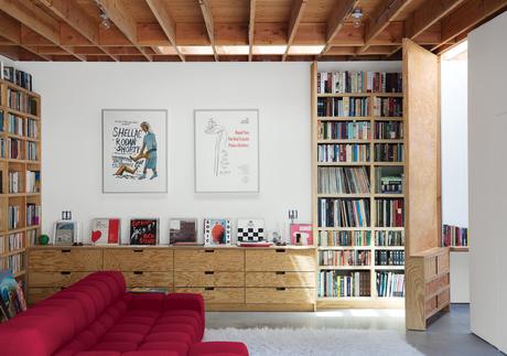 Family room with hinged tall door and bookcases