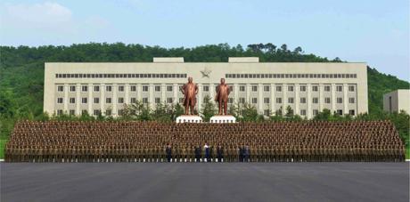 Commemorative photograph of Kim Jong and senior WPK Munitions Industry Department officials with the administration and faculty of the National Defense Industry (Photo: Rodong Sinmun).