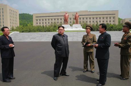 Kim Jong Un on the campus of the National Defense University.  Also in attendance are WPK Vice Chairman for Munitions Industry Ri Man Gon (2nd right) and WPK Munitions Industry Department Deputy Director Yu Jin (left) (Photo: Rodong Sinmun).