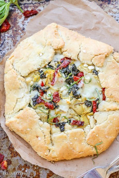 This Spinach + Artichoke Mediterranean Galette has sun-dried tomatoes, artichoke hearts, feta cheese, and gooey mozzarella tucked into a flaky gluten-free and grain-free crust. Pair with a side salad for the perfect lunch or dinner.