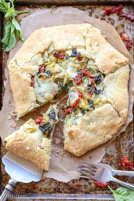 This Spinach + Artichoke Mediterranean Galette has sun-dried tomatoes, artichoke hearts, feta cheese, and gooey mozzarella tucked into a flaky gluten-free and grain-free crust. Pair with a side salad for the perfect lunch or dinner.