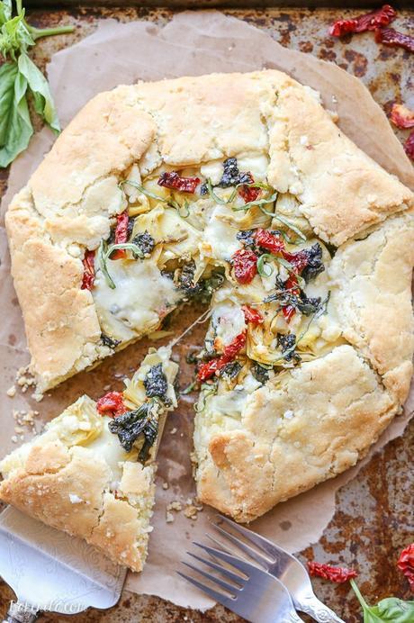 This Spinach + Artichoke Mediterranean Galette has sun-dried tomatoes, artichoke hearts, feta cheese, and gooey mozzarella tucked into a flaky gluten-free and grain-free crust. Pair with a side salad for the perfect lunch or dinner.