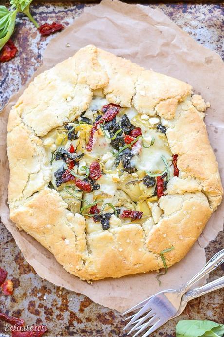 This Spinach + Artichoke Mediterranean Galette has sun-dried tomatoes, artichoke hearts, feta cheese, and gooey mozzarella tucked into a flaky gluten-free and grain-free crust. Pair with a side salad for the perfect lunch or dinner.