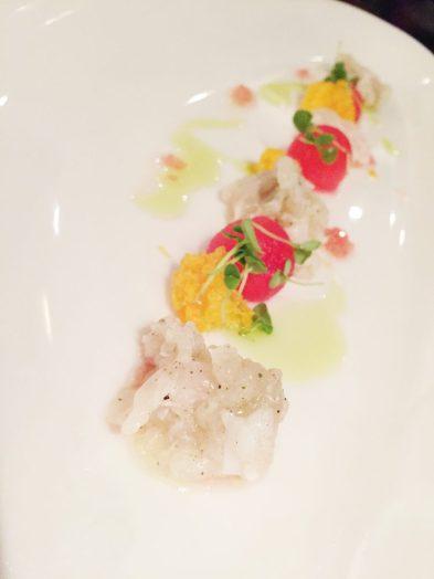 Strawberry gum cured crocodile cerviche served with finger lime dressing, watermelon, micro basil and freeze dried mandarin.