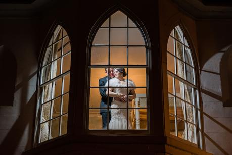couple in window - Warwick House Weddings