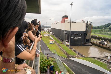 Visitors watch ships transit Miraflores Locks at the Panama Canal