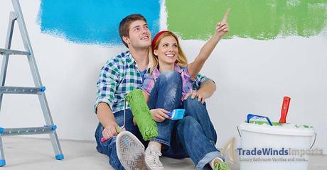 happy young couple relax after painting white wall in green and blue color in their new home