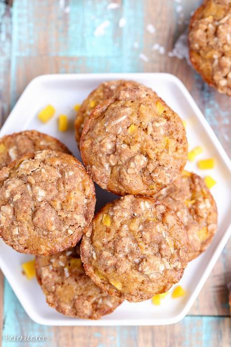 These Mango Coconut Crumble Muffins are tender and full of tropical flavor! These vegan muffins use coconut oil, coconut flakes, and fresh diced mango for a treat that will make you feel like you're on vacation.