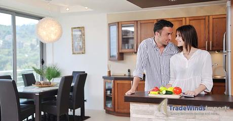 happy young couple have fun in modern wooden  kitchen indoor while preparing fresh food