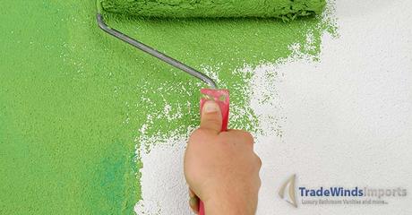 handsome young man paint in blue and green color  white wall of new home