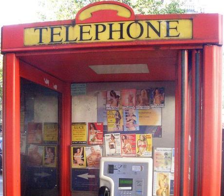 Tart cards in a British phone box advertising ...