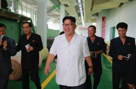 Kim Jong Un tours the P'yo'ngso'ng Synthetic Leather Factory in a photo that appears on the cover of the July 12, 2016 edition of the WPK daily newspaper Rodong Sinmun. Also in attendance, second from left, is DPRK Premier Pak Pong Ju (Photo: Rodong Sinmun).