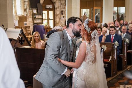 a bride and grooms first kiss