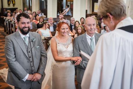 groom and bride and her father in a church 