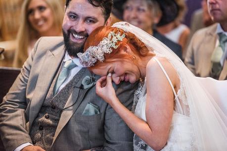 bride laughing on the grooms shoulder 