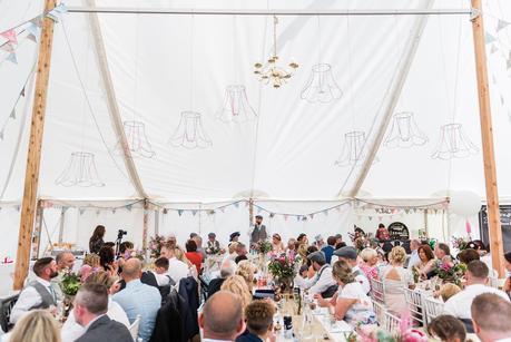 a wide angle photograph of the groom giving his wedding speech