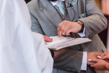 groom picking up her wedding ring