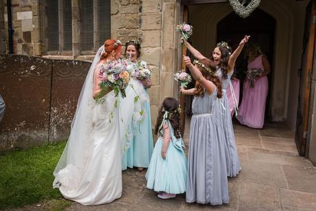 Flower girl with arms in air outside the church