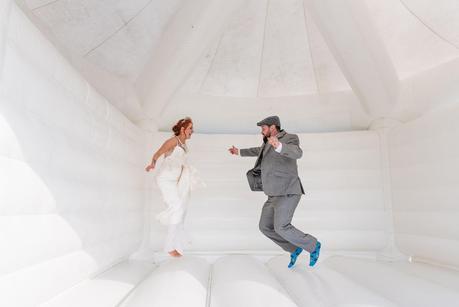 bride and groom on bouncy castle 