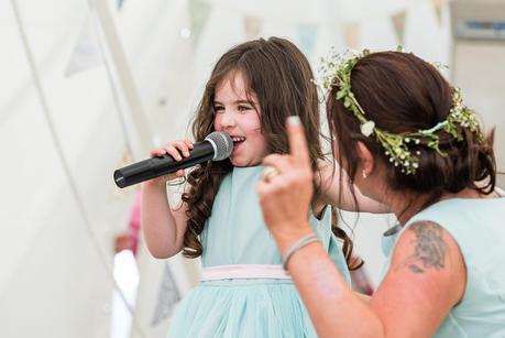 flower girl signing at the wedding reception