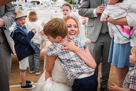 a bride hugging a wedding guest