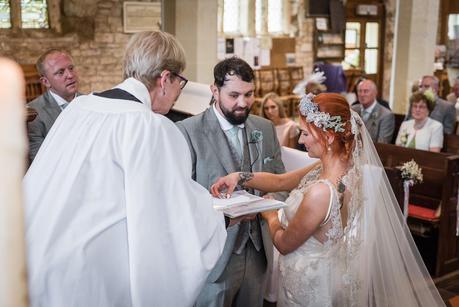 bride picking up her wedding ring