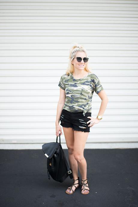 Summer style; camo tee tied in a knot, black ripped jean shorts and strappy sandals. Simple, chic, and trendy looks for women of all ages.