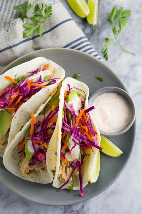 These Sweet Chili Chicken Tacos are made with slow cooker sweet chili chicken and topped with yogurt sauce. This dinner is ready in just 15 minutes!